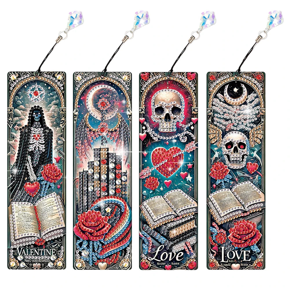 Four decorative bookmark-style cards with gothic illustrations, each featuring a skull, heart, book, rose, and ornate frame design. The bookmarks have black strings with iridescent beads at the top and are arranged side by side 