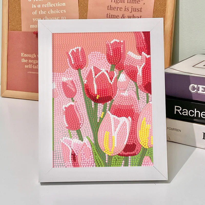 A framed diamond painting featuring pink and red tulips with green stems on a pink background