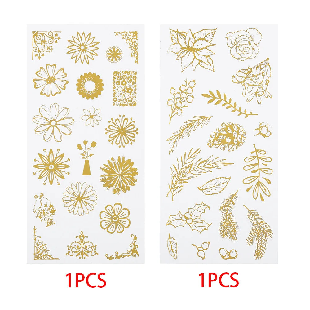 Two sheets of gold floral and botanical line art stickers each labeled '1PCS' in red text below. The designs include flowers, leaves, vines, and ornamental corner motifs.
