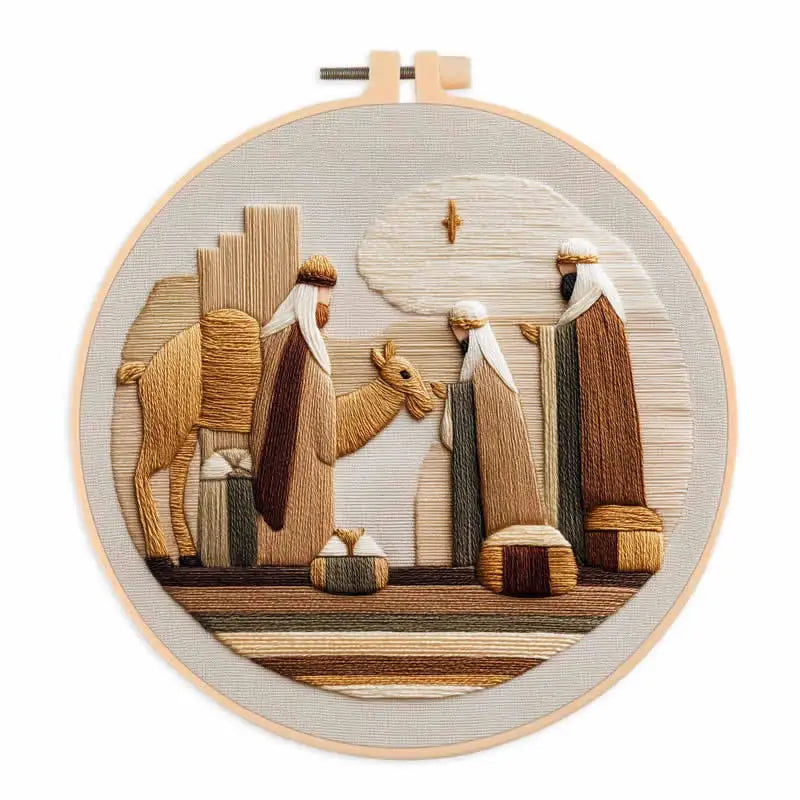Three wise men and a camel with big packages on the ground next to them and a star above them  in an embroidery hoop frame