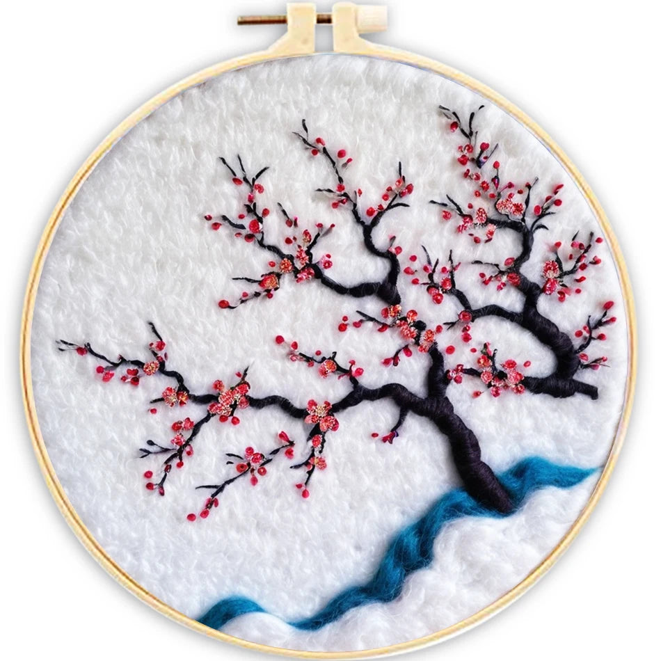 Embroidery hoop with cherry blossom design on a white background