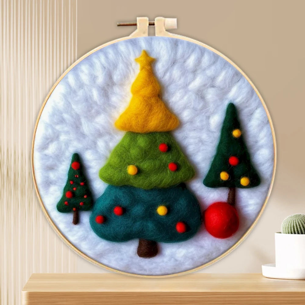 Three wool needled Christmas trees on a blue background