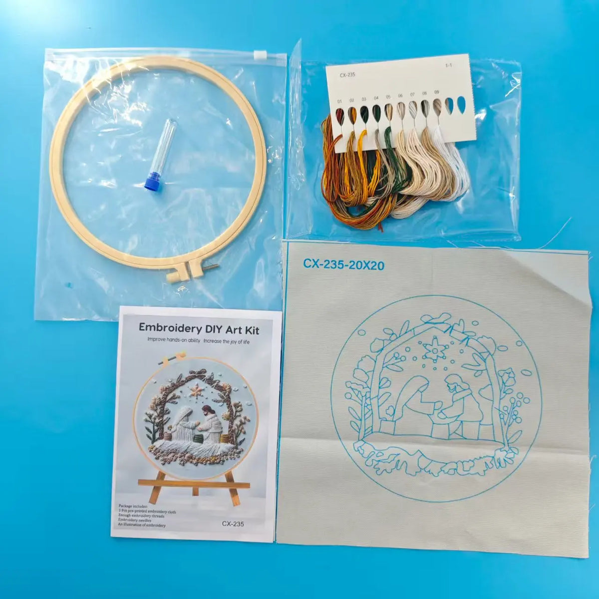 photo of kit with embroidery floss, printed canvas, embroidery hoop and instructions
