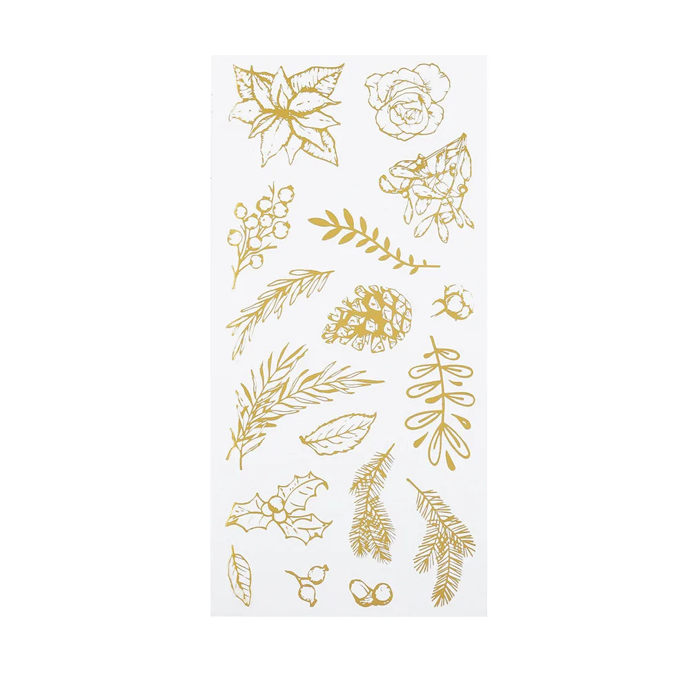 A sheet of translucent stickers featuring gold botanical and floral designs, including flowers, pinecones, leaves, and berries