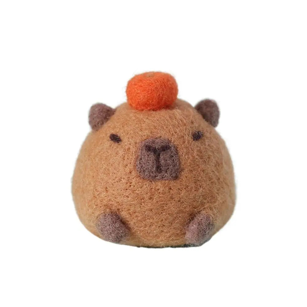 Small Needle felted toy resembling a beaver with an orange top on a white background
