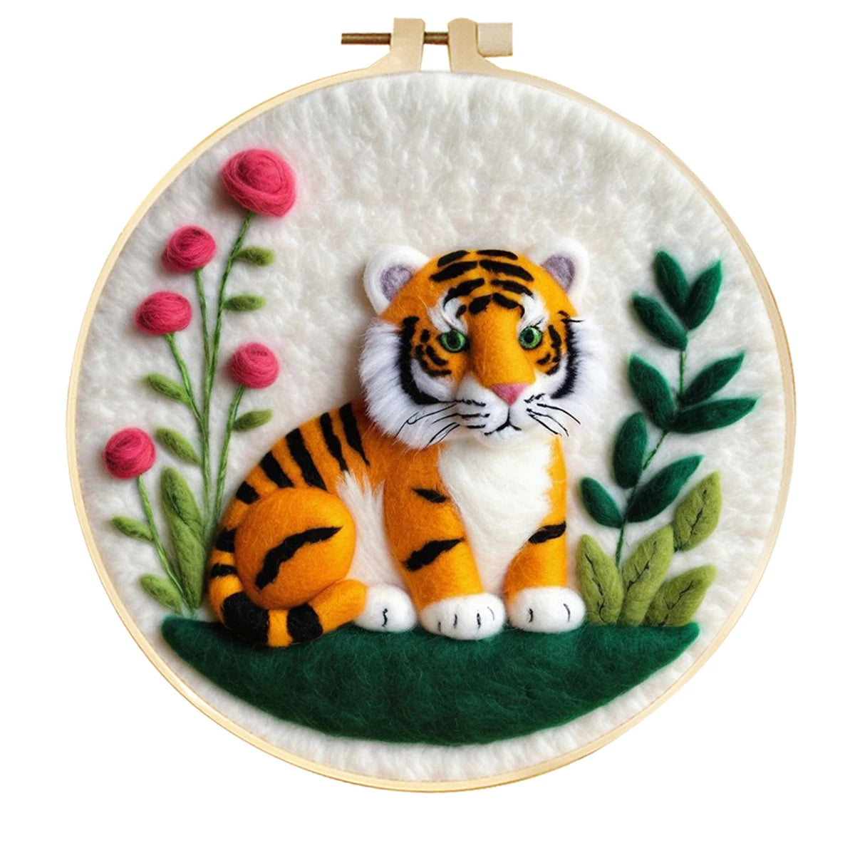 needle felted tiger sitting on dark ground with pink flowers and greenery against a white background in a round hoop frame