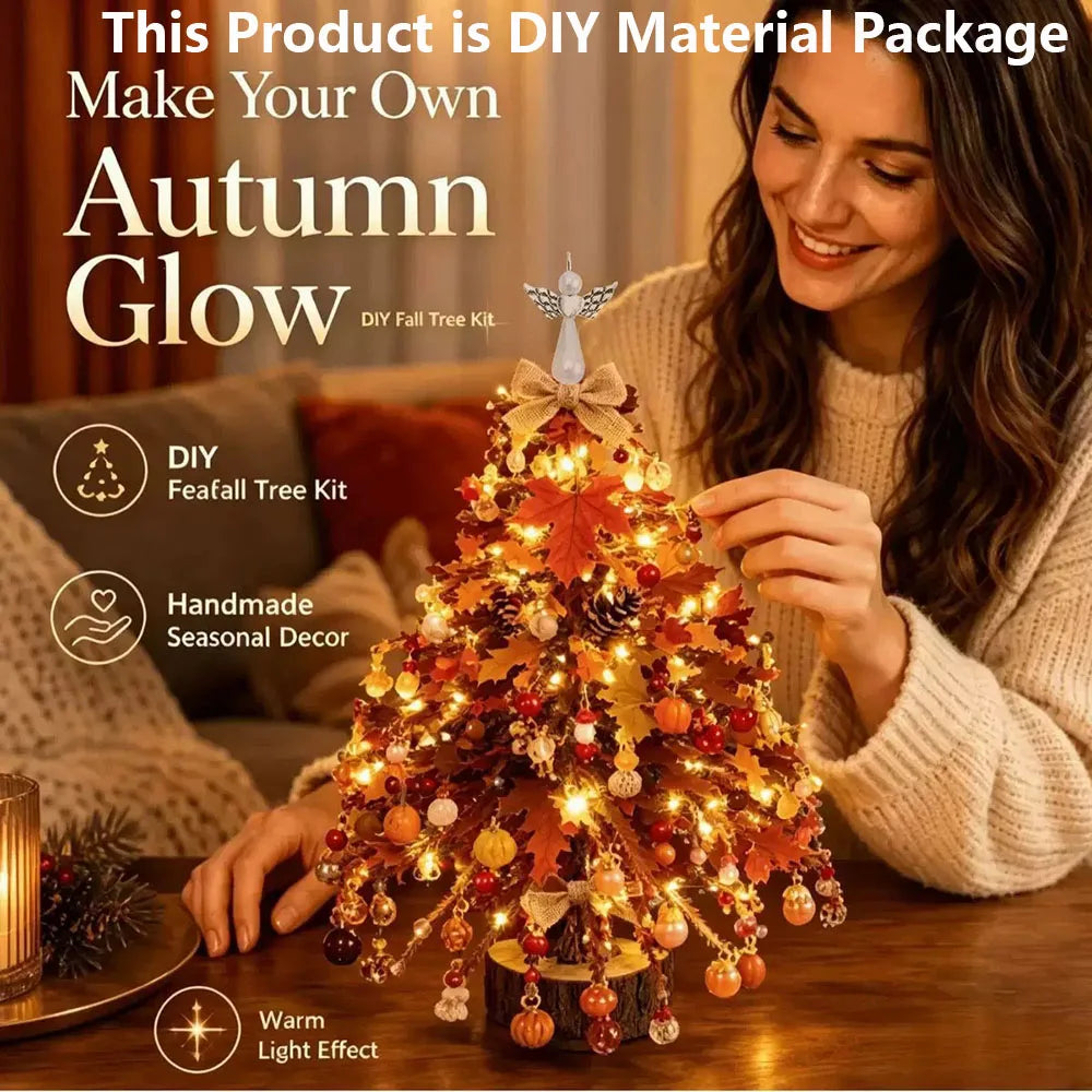 A woman in a cream knit sweater decorates a small DIY feathery Christmas tree kit with warm white lights, autumn leaves, pinecones, and colorful ornaments on a wooden table. Large promotional text at the top reads 'This Product is DIY Material Package' and 'Make Your Own Autumn Glow DIY Tree Kit,' with feature icons below.