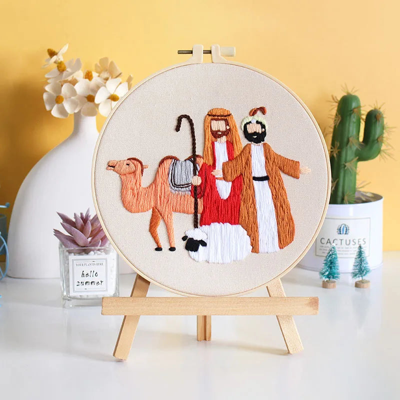 Embroidery hoop with a religious scene featuring two men, a sheep and a camel