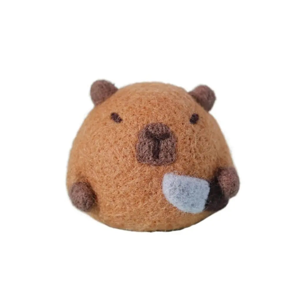 Round brown needle felted bear face on a white background