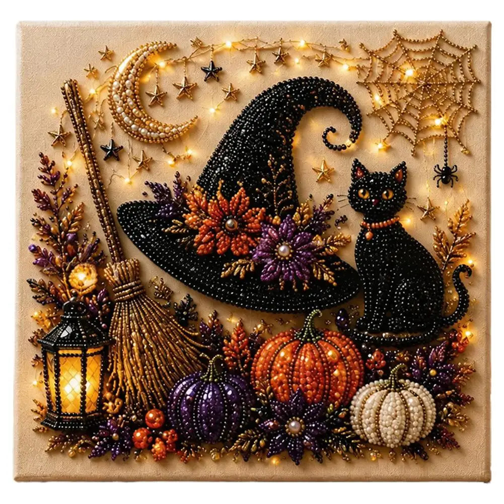 A square decorative wall art piece featuring a beaded Halloween scene with a black witch hat, black cat, broom, lantern, pumpkins, spiderweb, stars, and warm string lights on a beige background.