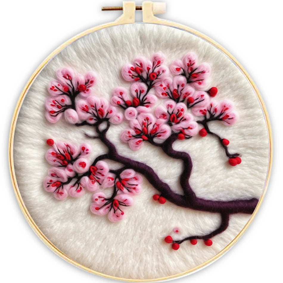 Embroidery hoop with cherry blossom design on a white background