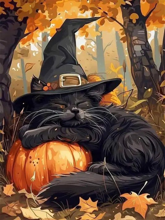 A diamond art black cat wearing a tall black witch hat rests on an orange pumpkin in an autumn forest with falling leaves and trees in the background.