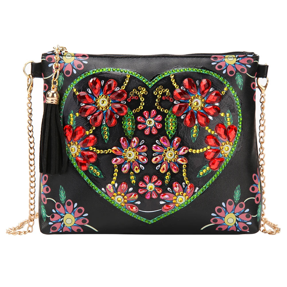 Black handbag with colorful floral heart design with diamond art embellishments and gold chain strap
