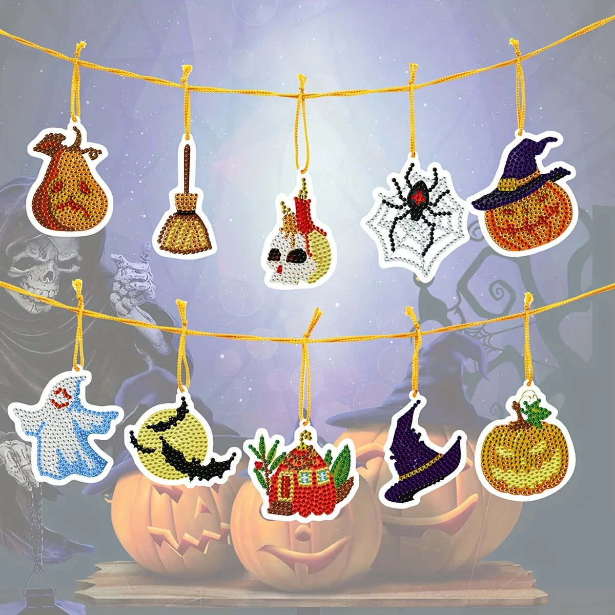 Halloween-themed diamond painting ornaments hanging on a line, including a ghost, bats, witches hat, pumpkins, spider, skeleton, and broom