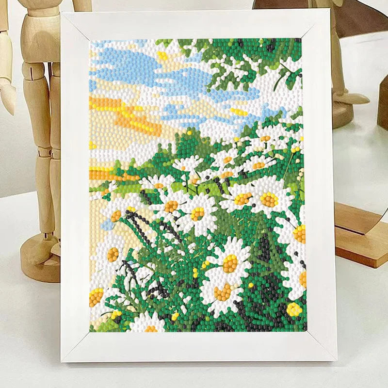 A framed diamond painting depicting a field of white daisies with yellow centers under a blue and yellow sky