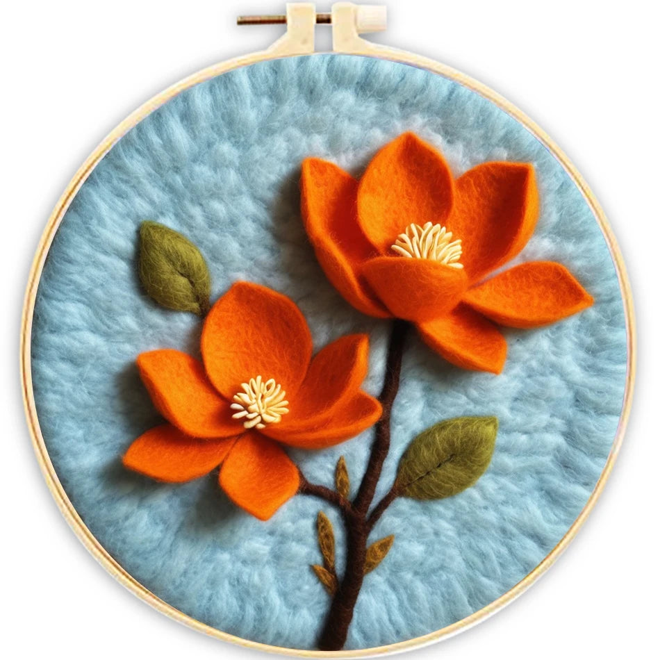 Embroidery hoop with orange flowers and green leaves on a blue background