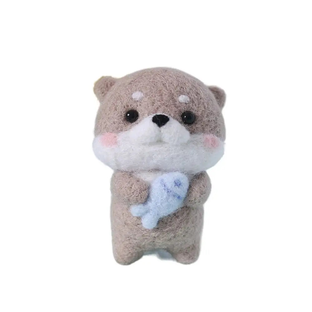 Needle Felted otter holding a fish on a white background