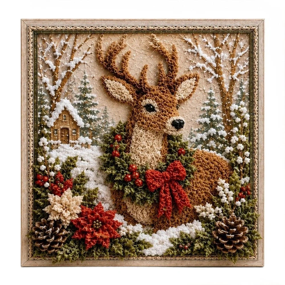 A square framed decorative punch needle artwork showing a reindeer in a snowy winter landscape, pinecones, evergreen branches, red berries, and a small cabin. 