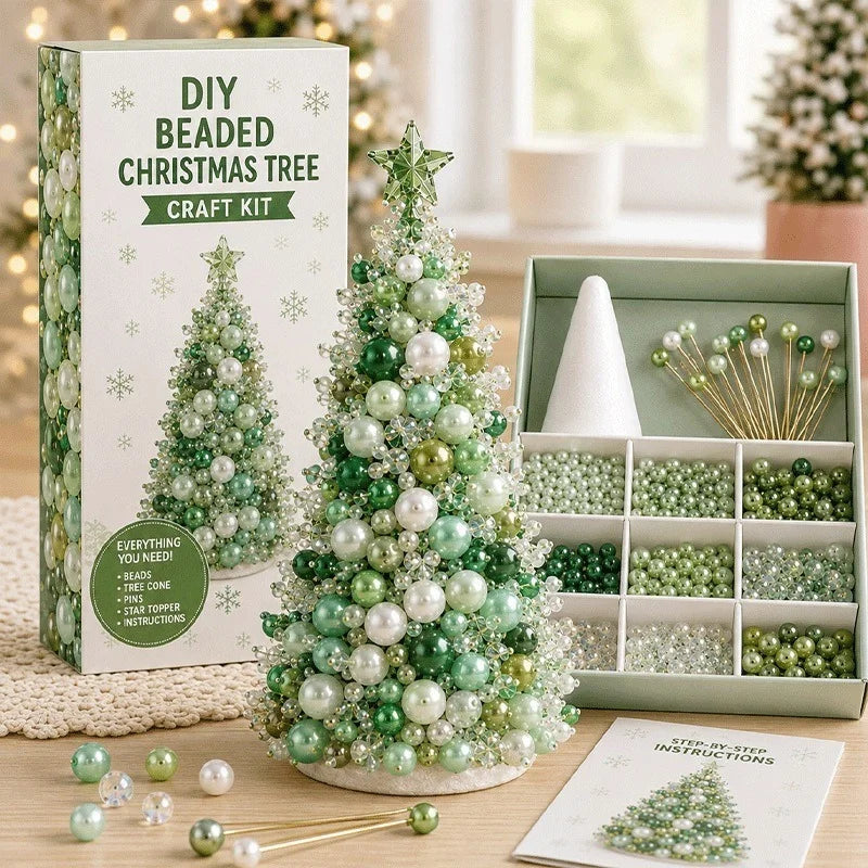 DIY Beaded Christmas Tree Craft Kit displayed with its packaging box, a completed green and white beaded tree, an open organizer box of beads and gold wire picks, and an instruction card on a tabletop.