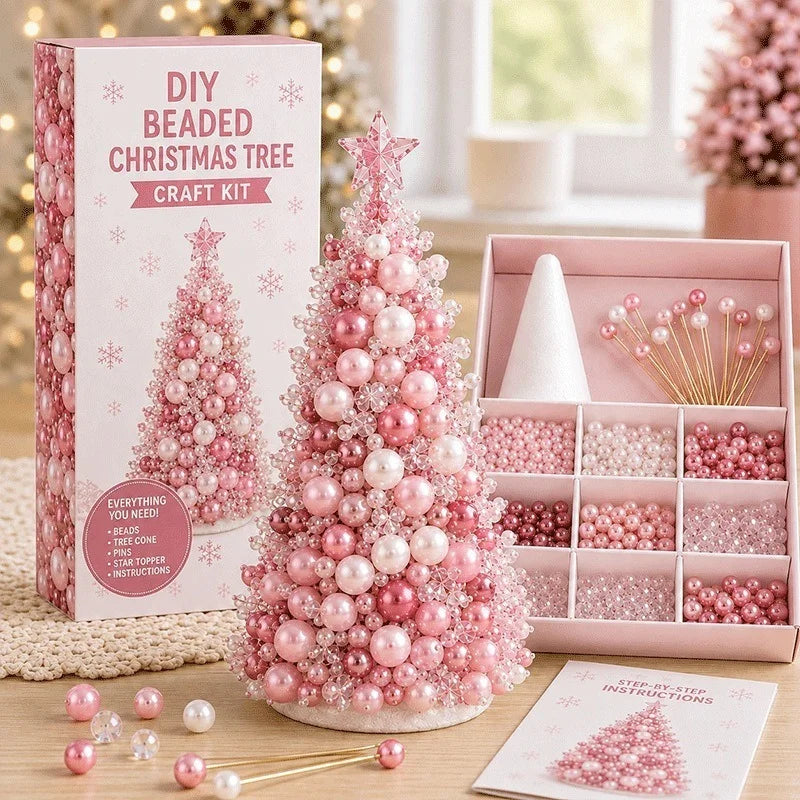 DIY Beaded Christmas Tree Craft Kit shown with its retail box, a completed pink beaded Christmas tree, an open box of beads and tools, and a card with bead tips on a tabletop.