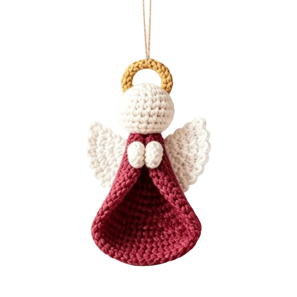 A crocheted angel hanging ornament with a cream-colored head and wings, a deep red skirt, and a tan ring at the top for hanging