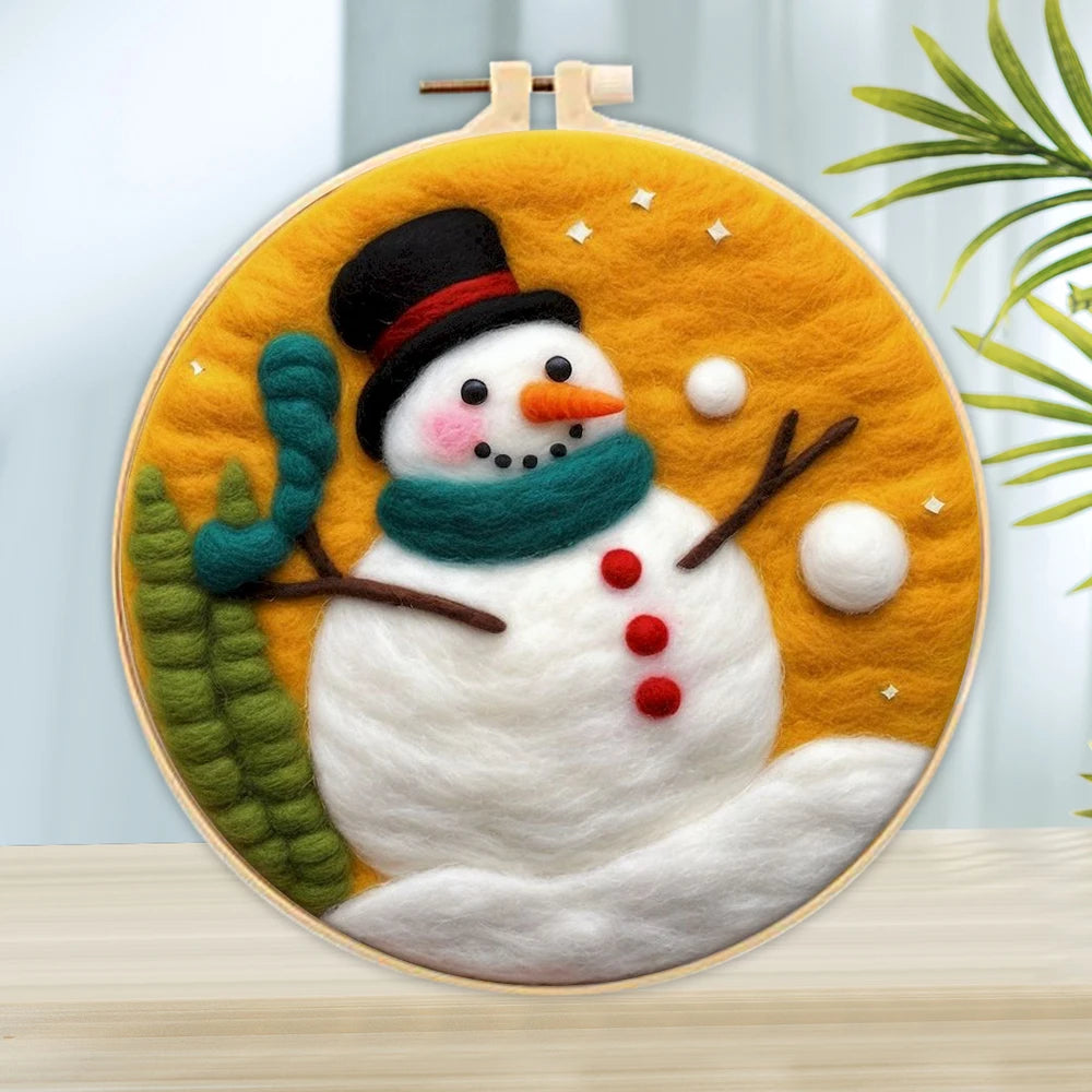 Wool needle felted snowman wearing a black hot, teal scarf, carrot nose, branch arms, and black eyes, and red buttons on an orange background