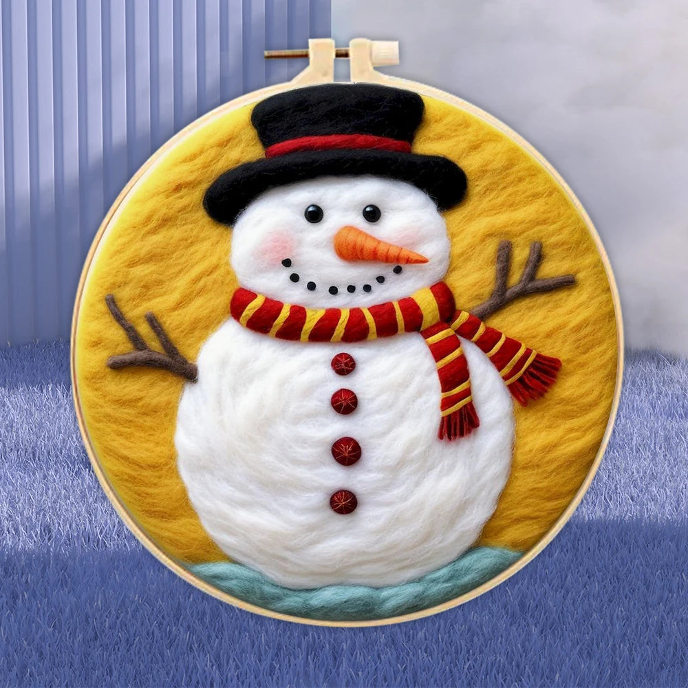 Wool needle felted snowman wearing a black hot, red and gold striped scarf, carrot nose, branch arms, and black eyes on an orange background