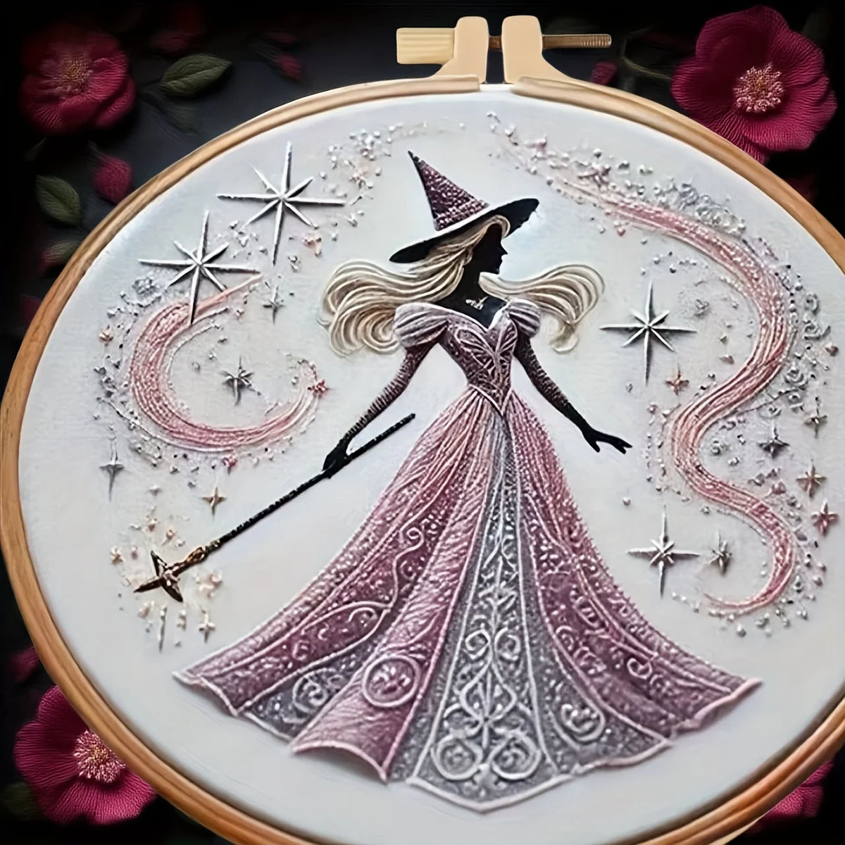 Embroidery hoop with a witch design surrounded by stars and flowers