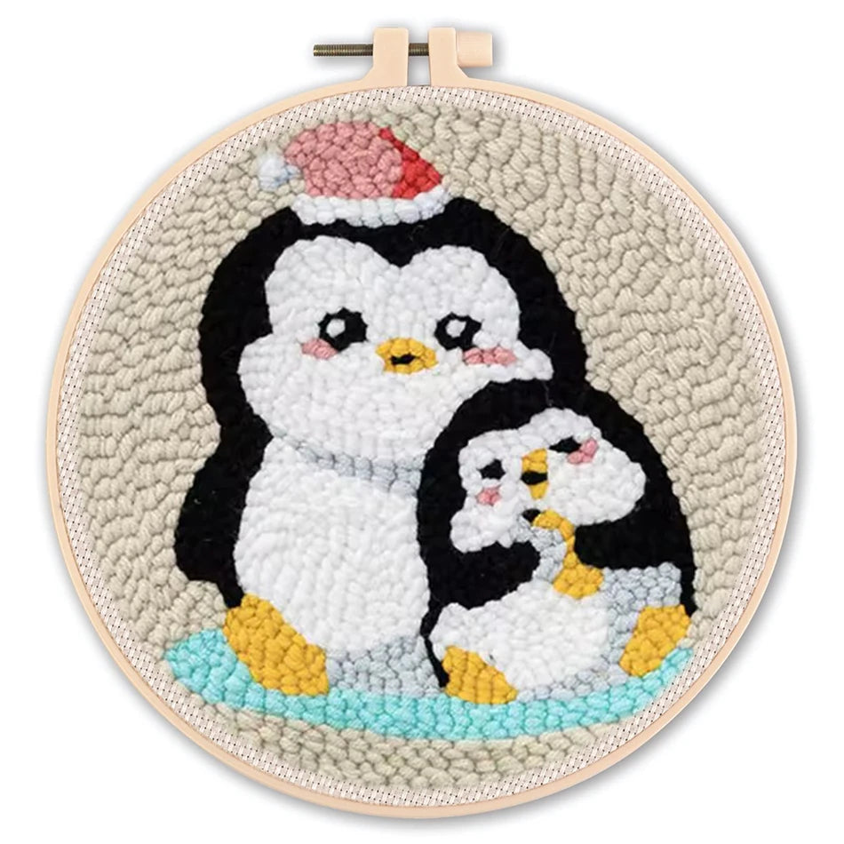 Embroidery hoop with penguin design on a white background