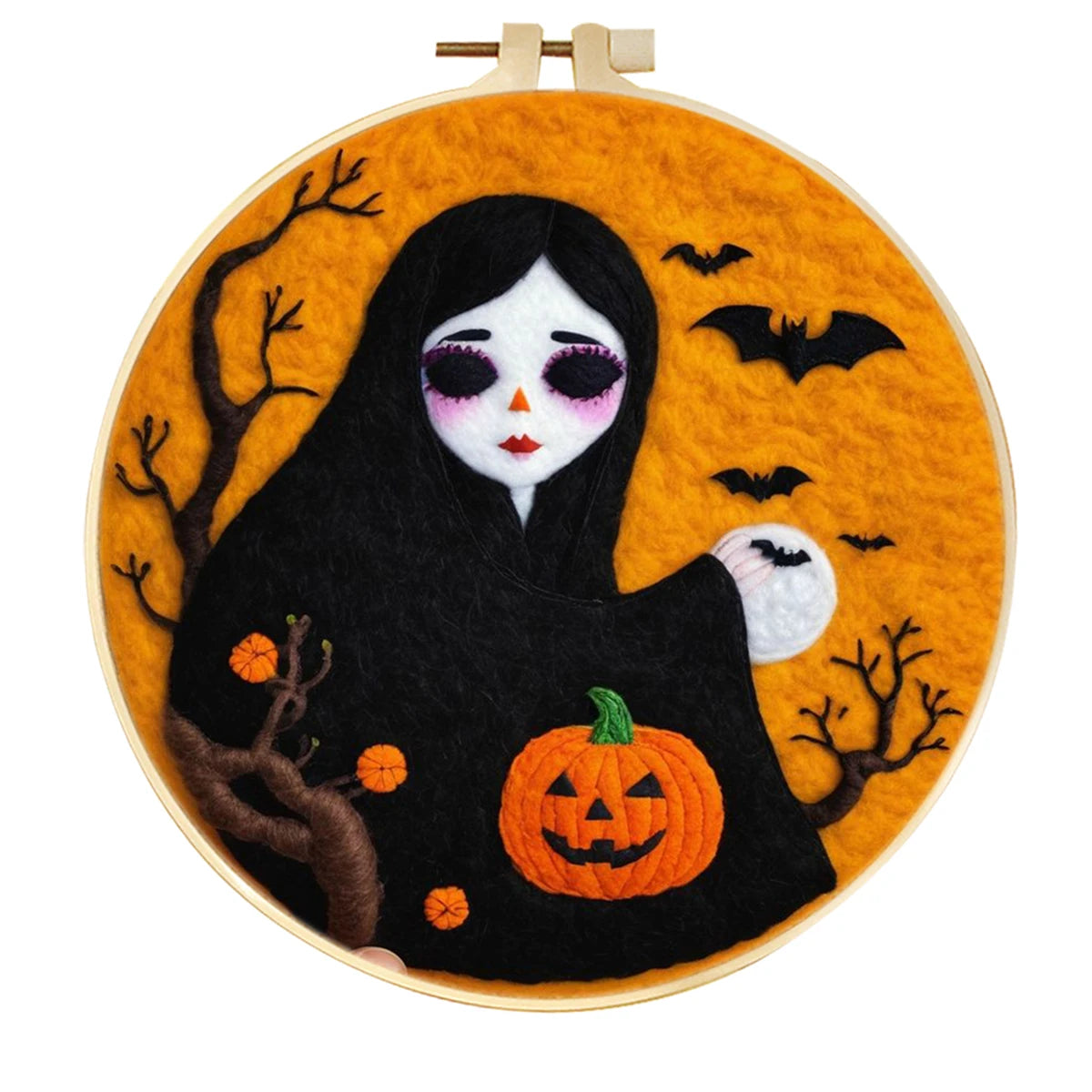 Embroidery hoop with a Halloween-themed needle felted design featuring a ghost, pumpkin, and bats on an orange background.
