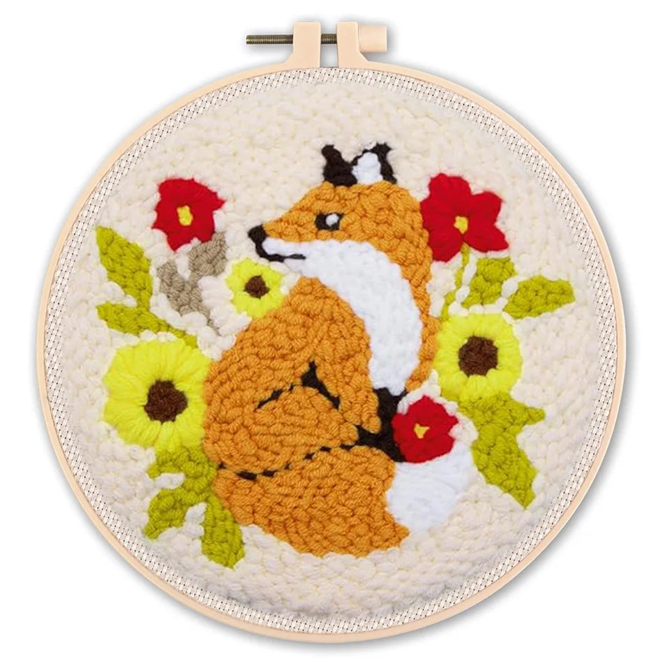 Embroidery hoop with a fox and floral design on a white background