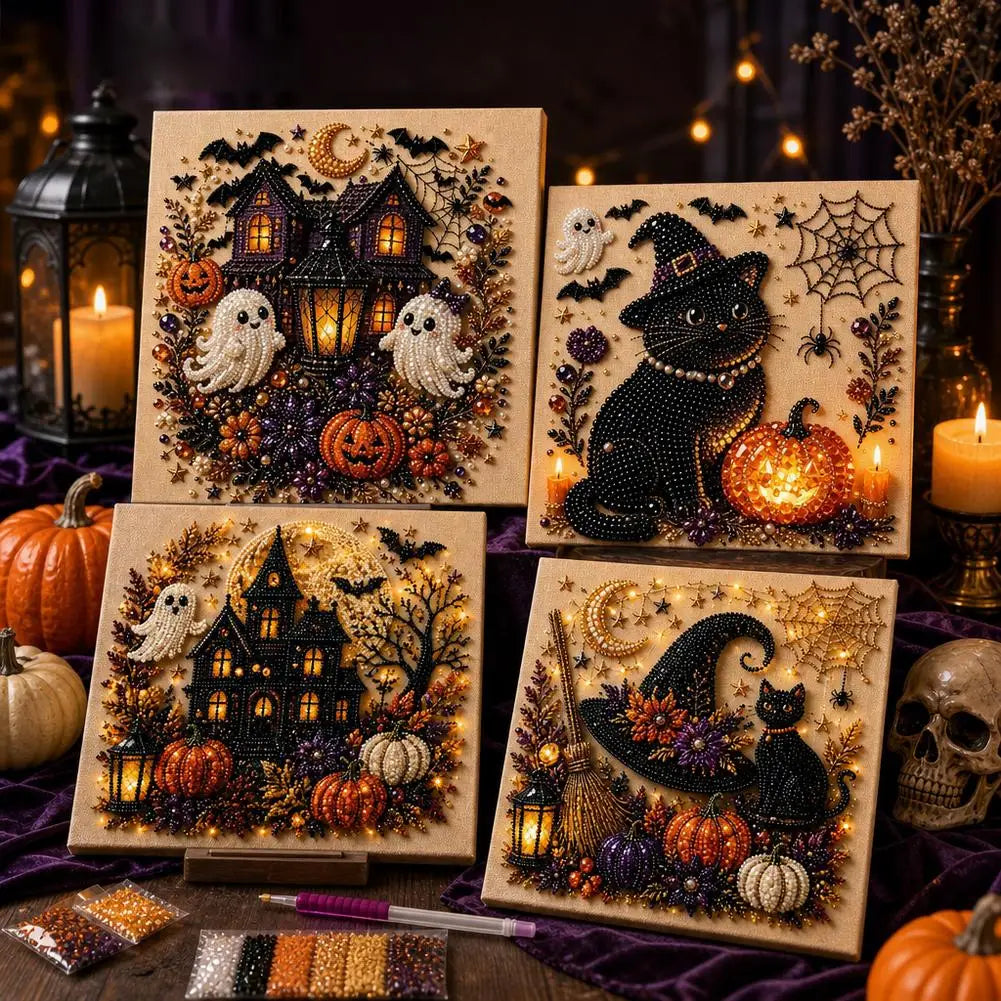 Three square Halloween-themed beaded wall art panels displayed on a dark table with candles, pumpkins, and decorative props. The designs feature a haunted house, a black cat in a witch hat, and a witch broom, all embellished with black, orange, purple, white, and gold beads, with small LED lights embedded in the pieces.
