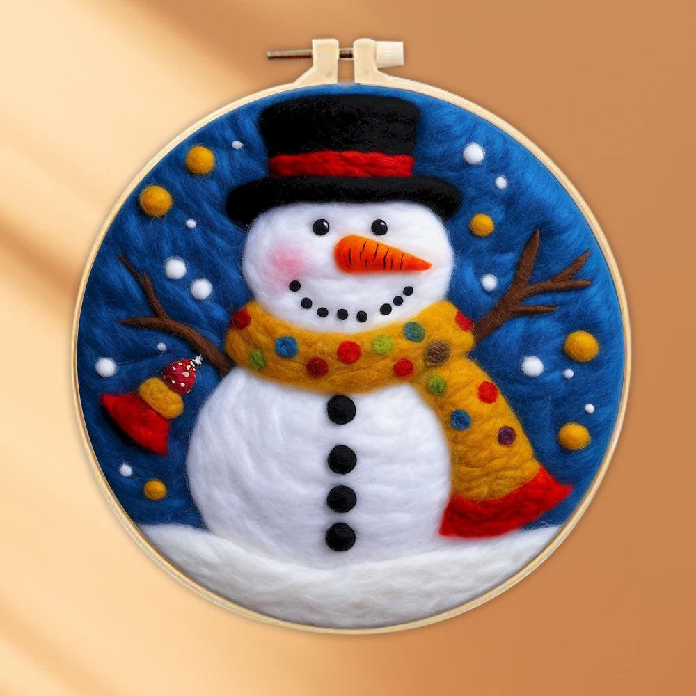 Wool needle felted snowman with a black hat, carrot nose, brown scarf with polka dots, and a night sky with stars