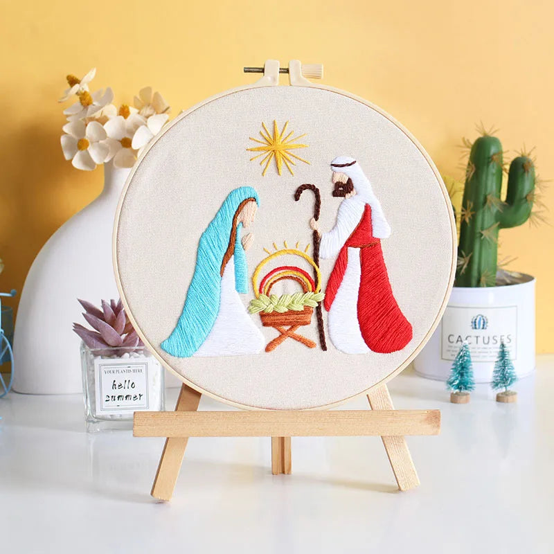 Embroidery hoop with nativity scene design on a wooden stand 