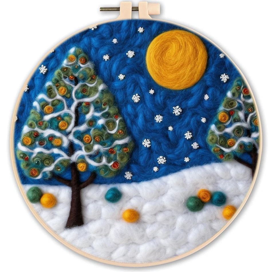 Needle felted winter night scene with a full moon, snowflakes and decorated trees and snow on the ground